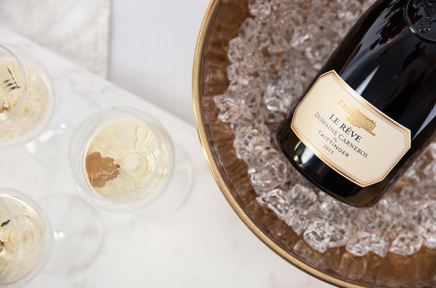 Le Rêve in Gold Ice Bucket with glasses of sparkling wine 